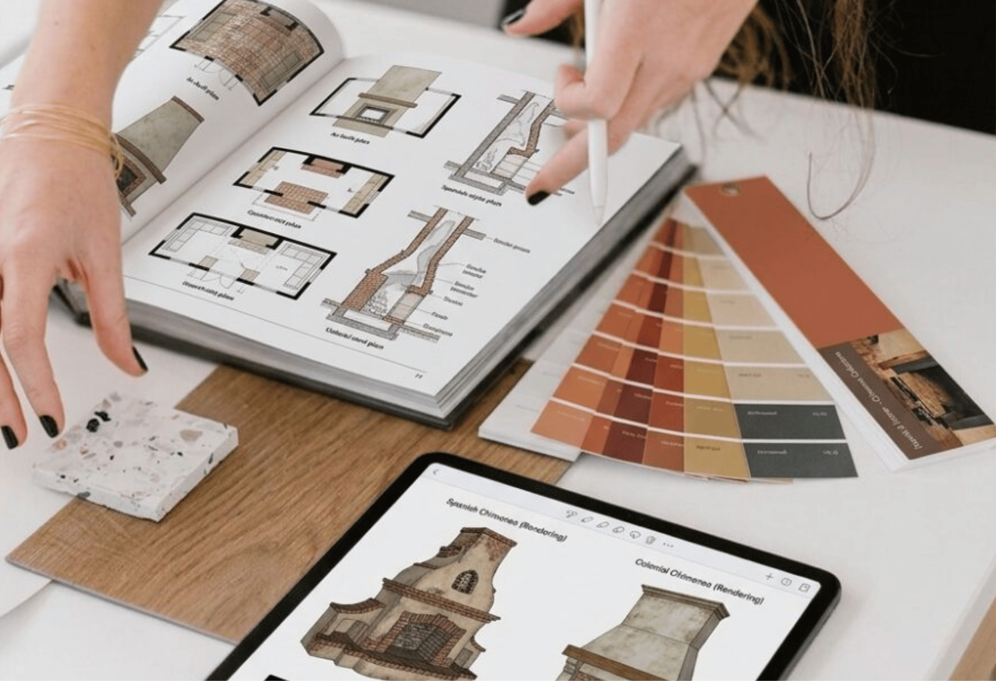 Persona revisa planos y muestras de materiales para diseñar una chimenea moderna.